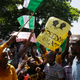 People hold banners as they demonstrate on the street to protest against police brutality, in Lagos, Nigeria, Tuesday, Oct. 20, 2020. After 13 days of protests against police brutality, authorities have imposed a 24-hour curfew in Lagos, Nigeria’s largest city in an attempt to quell growing violence.